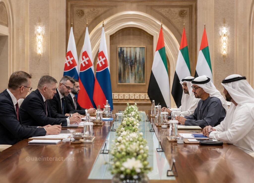 UAE President Sheikh Mohamed and Slovak Prime Minister Robert Fico Discuss Expanding Bilateral Cooperation 2 - UAE Interact Two delegations meet at a formal conference table, Slovakia and UAE flags visible behind them, with a white floral centerpiece down the middle.
