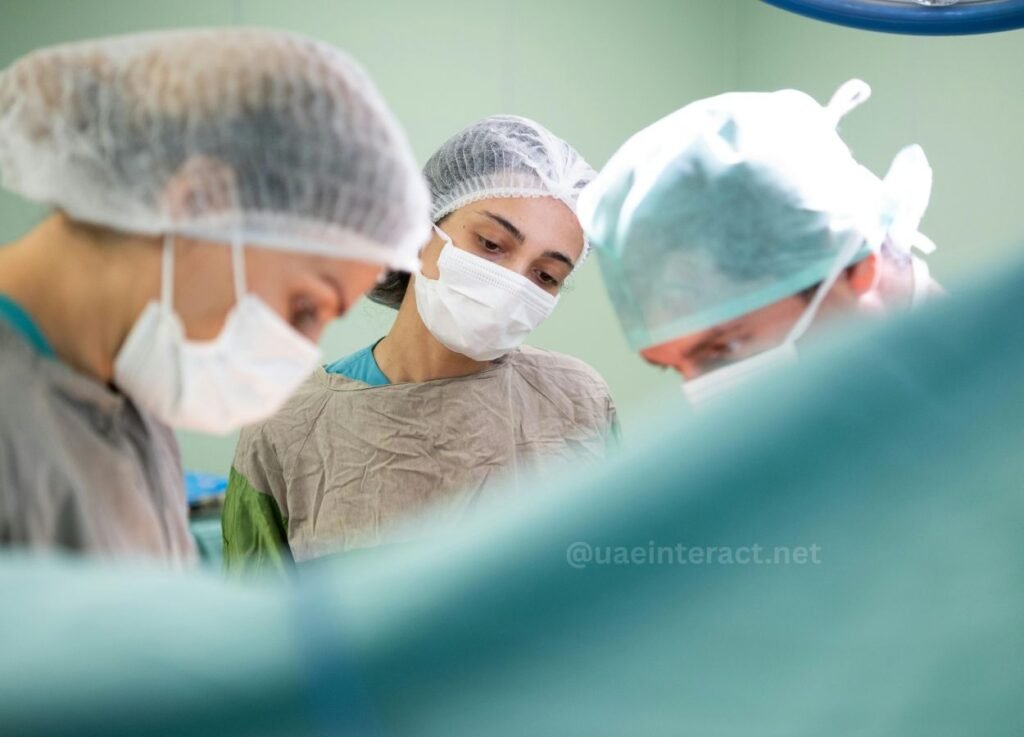 UAE Surgeons Warn Women Against Dangerous XS-XL Cosmetic Surgery Trend - UAE Interact Surgeons in scrubs and masks performing a procedure in a sterile operating room.