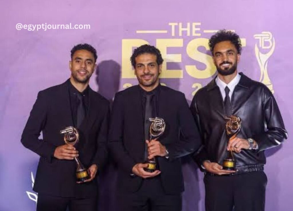 egyptjournalcom 5 - UAE Interact Three men in black suits hold golden trophies at an awards ceremony against a purple backdrop that reads 'THE BEST'.